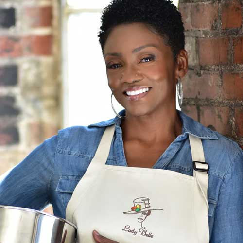 Chef Charlette Bell wearing and apron and smiling at the camera.