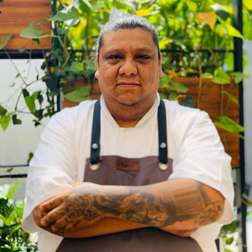 Portrait of Linger Longer Steak House Chef JC Martinez with arms crossed.
