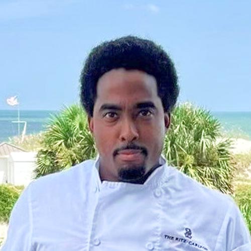 Headshot of the Amore del Lago Sous Chef Marcus Davis looking serious at the camera.