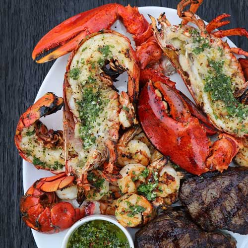 Offerings from Scratchers Creek showing a close up of a seafood and steak dinner.
