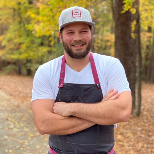 Portrait of The Burch Food Truck Owner and Chef Casey Burchfield, in front of Fall trees.
