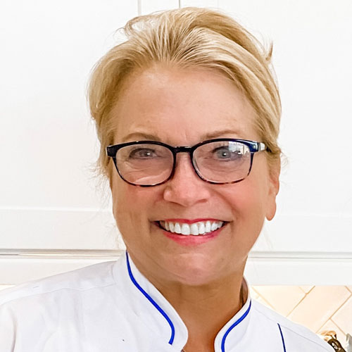 A headshot of private chef Deborah Johnson, smiling at the camera.