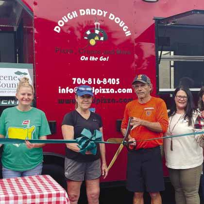 Photo of the Dough Daddy Dough team smiling at their ribbon cutting.